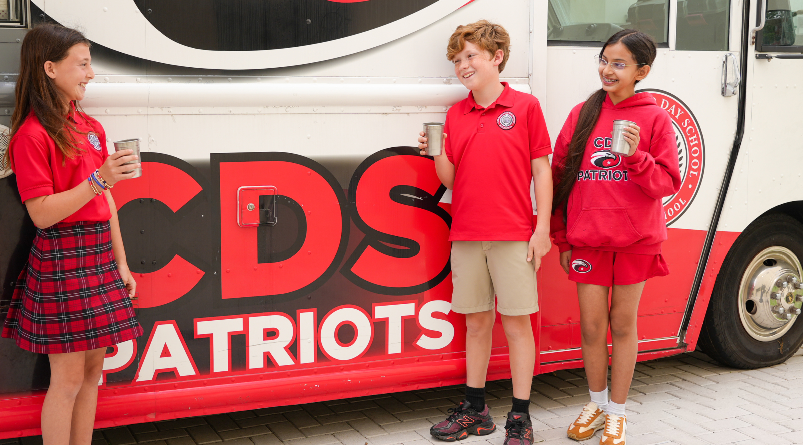 Carrollwood Day School students using new stainless steel cups