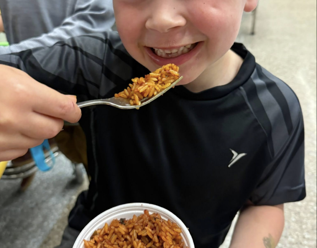 Student happy using a reusable stainless steel fork